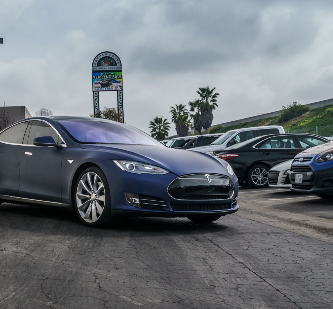 A navy 2012 to 2016 Model S seen from the front, three-quarter view